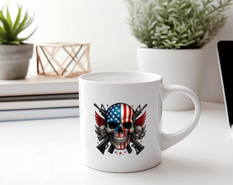 May include: White ceramic mug featuring a skull design with the American flag on one side and a detailed illustration of guns, wings, and stars. The mug has a curved handle and is suitable for hot or cold beverages.
