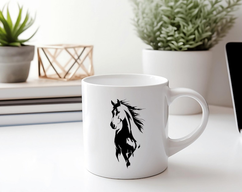 May include: White ceramic mug featuring a black silhouette of a horse. The horse design is on the front of the mug. The mug has a curved handle and is sitting on a white surface.