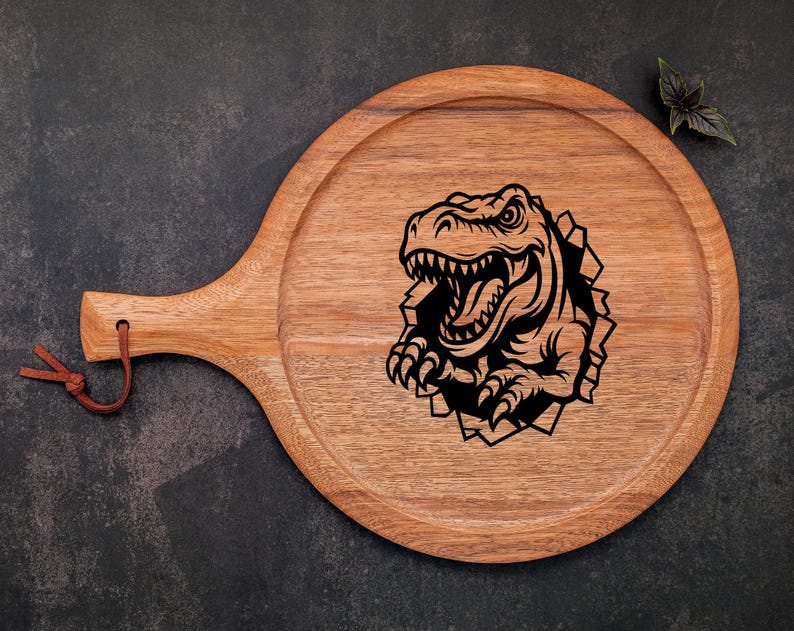 May include: A wooden serving board with a handle, featuring a black and white illustration of a dinosaur head breaking through the surface.