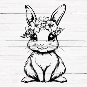May include: A black and white line drawing of a rabbit wearing a flower crown. The rabbit is sitting with its paws tucked under its body and has a sweet expression on its face.