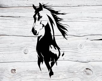 May include: A black and white graphic of a horse's head and upper body. The horse is depicted in a stylized, flowing design, with the mane and tail flowing. The background is a light-colored, weathered wood.