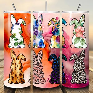 May include: A set of six stainless steel tumblers with various bunny designs. The designs include floral, leopard print, and watercolor patterns. Each tumbler has a straw and a colorful background with orange, pink, and red hues.