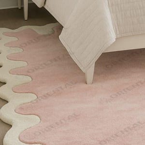 Modern wavy edge area rug 6x9 ft under neutral decor bed Luxury tufted rug 5x7 ft pink wavy design in bedroom.