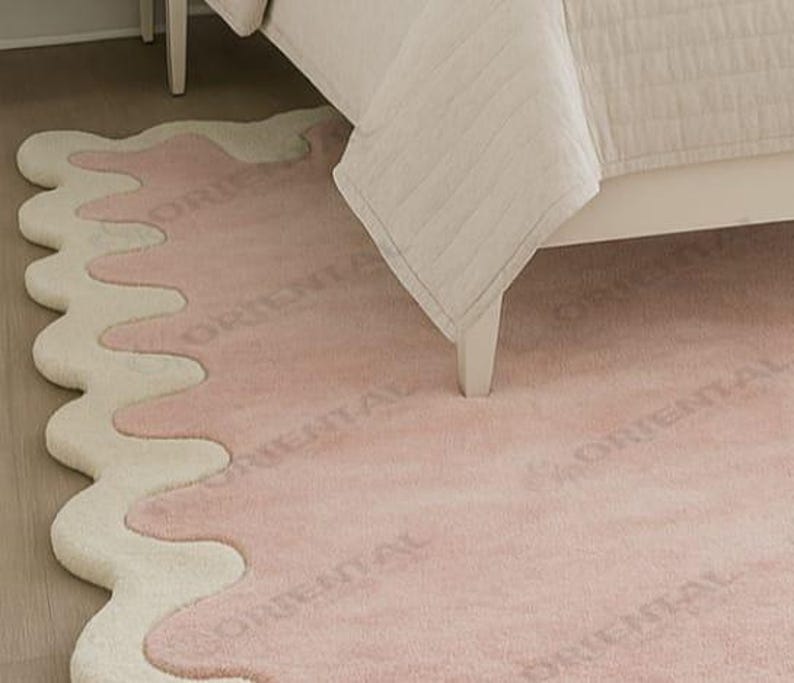 Modern wavy edge area rug 6x9 ft under neutral decor bed Luxury tufted rug 5x7 ft pink wavy design in bedroom.