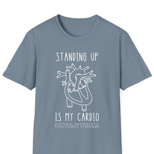 May include: A light blue t-shirt with a white outline of a heart and the text "Standing Up Is My Cardio" and "Postural Orthostatic Tachycardia Syndrome".