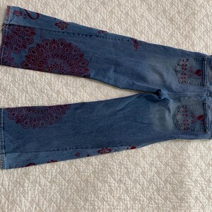 Back pockets feature garlands, hearts and roses