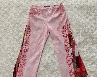 Pretty in Pink jeans with Rangoli style stenciled borders in red. Hand quilted gussets create a flared leg. Hearts & roses complete the look