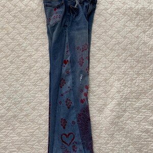 Side gusset added for comfort and a flare leg. Also stenciled with hearts, roses and the word "love"