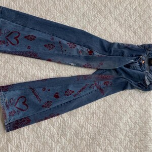 Denim gussets show hearts,roses, garlands and the word "love"