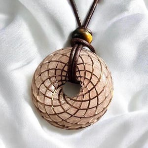 Pink Torus Rose Quartz Necklace / Rodin Coil Pendant. Wrapped with pure copper coil (antique brass finish)  and adjustable leather cord.