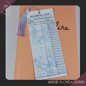 a reading list card with a tassel attached, placed on top of a folder or book.