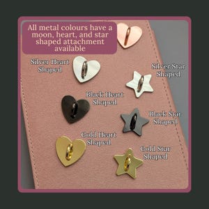Stag Throne of Glass Inspired Charm Keychain. A collection of metal attachments in heart and star shapes, available in silver, black, and gold finishes.