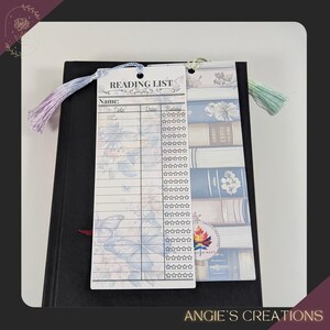 a reading list with a black binder and a white paper bookmark. The reading list includes the names of various books, and there is a tassel attached to the binder.