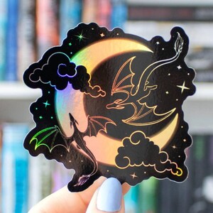 Moon and Dragons Acrylic Kindle Grip. A die-cut sticker featuring a holographic crescent moon against a black background.