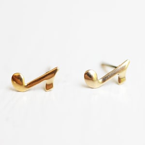 May include: A pair of gold-tone musical note earrings. The earrings are small and delicate, and they would make a great gift for a music lover.