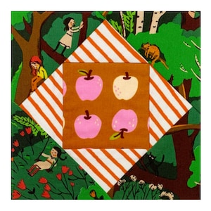 May include: A patchwork quilt block with a central square featuring a brown background with four pink and white apples. The surrounding squares are green with white stripes and feature various illustrations of people and animals in a forest setting.