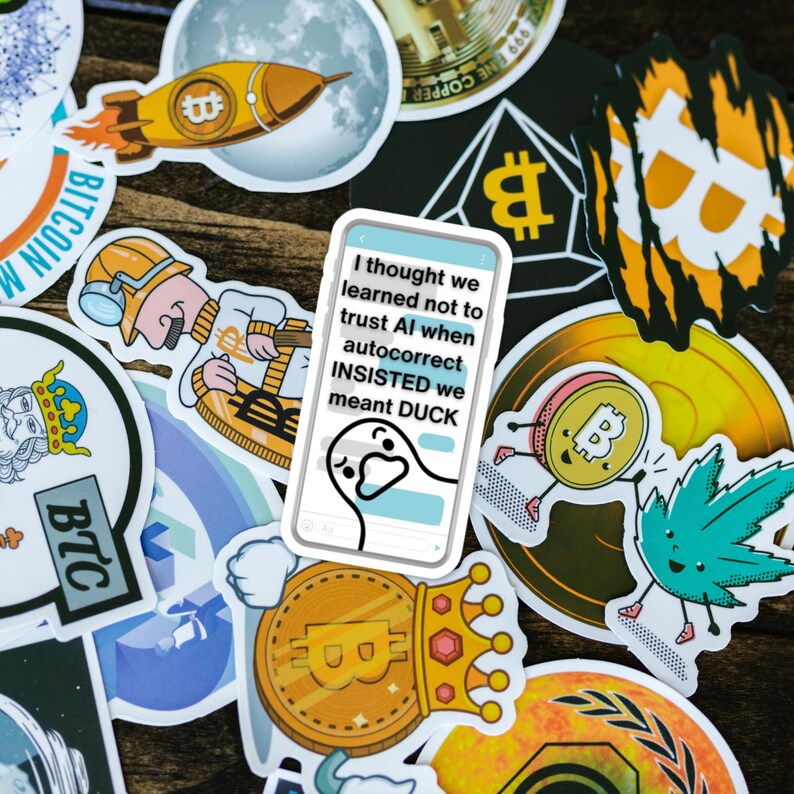 May include: A collection of colorful stickers with cryptocurrency themes. Designs include Bitcoin logos, a rocket ship, a moon, and a sticker with the text "I thought we learned not to trust AI when autocorrect INSISTED we meant DUCK."