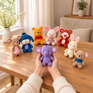 May include: A collection of small, handmade crochet stuffed animals featuring various characters including a yellow bear, a pink piglet, a blue donkey, a striped tiger, a yellow rabbit, a purple elephant, and two small brown mice with colorful shirts.
