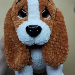 Peut inclure: Une peluche faite &agrave; la main repr&eacute;sentant un chien beagle. Le jouet est marron, blanc et noir, avec de grands yeux expressifs et des oreilles tombantes. Le chien a un nez noir et est fait d'une mati&egrave;re douce et textur&eacute;e.