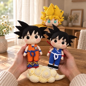 May include: Two crocheted dolls featuring black spiky hair and round black eyes. One doll wears an orange jumpsuit with a white circular emblem, the other a blue jumpsuit with a white sash. A third yellow-haired doll head sits behind them.