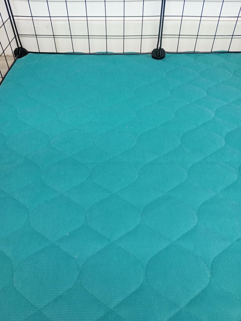 May include: Teal quilted cage liner with a diamond pattern. The liner is made of a soft, durable material and is perfect for keeping your pet's cage clean and comfortable.