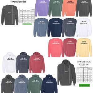 May include: A collection of Comfort Colors sweatshirts and hoodies in various colors, including gray, blue, and pink. Each garment features the text "LET THE SHOW GO ON" in white. Size charts are also included.