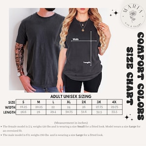 May include: Two people wearing dark gray t-shirts. The image includes a size chart with measurements in inches for adult unisex sizing, ranging from S to 4X. The text "COMFORT COLORS" and a logo are also visible.