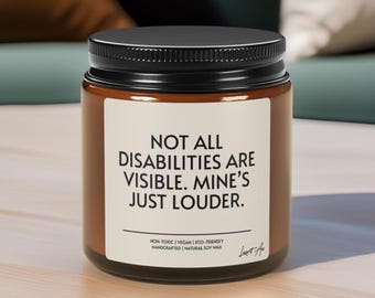 May include: A brown jar with a black lid and a white label. The label reads "NOT ALL DISABILITIES ARE VISIBLE. MINE'S JUST LOUDER." The jar is labeled as non-toxic, vegan, eco-friendly, handcrafted, and made with natural soy wax.