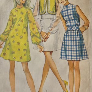 May include: Vintage sewing pattern illustration showing three young women in dresses. The dresses include a yellow floral print, a white dress with a yellow vest, and a blue and white plaid dress. The pattern size is 9/10 with a bust size of 77.5 cm.