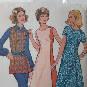 May include: Vintage sewing pattern featuring three illustrated women's fashion designs. The designs include a tunic and pants set with an orange and blue diamond pattern, a white and orange dress, and a blue patterned dress.