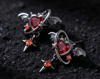 Pendientes góticos con forma de corazón y alas de murciélago, con circonitas rojo anaranjadas y colgante de estrella, cierre de plata 925.