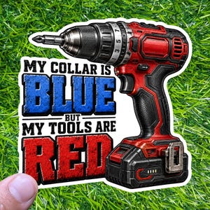 May include: A sticker featuring a red and black cordless drill with the text "MY COLLAR IS BLUE BUT MY TOOLS ARE RED" in blue and red distressed lettering. The sticker is on a green grassy background.