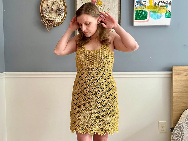May include: A yellow crochet dress with a scalloped hemline.
