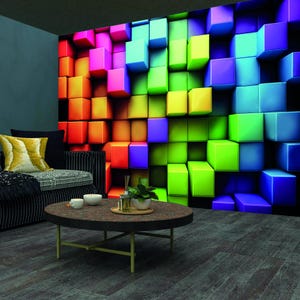 May include: A living room with a couch and a coffee table. The wall behind the couch is covered with a colorful 3D wallpaper featuring a pattern of cubes in shades of red, orange, yellow, green, blue, and purple.