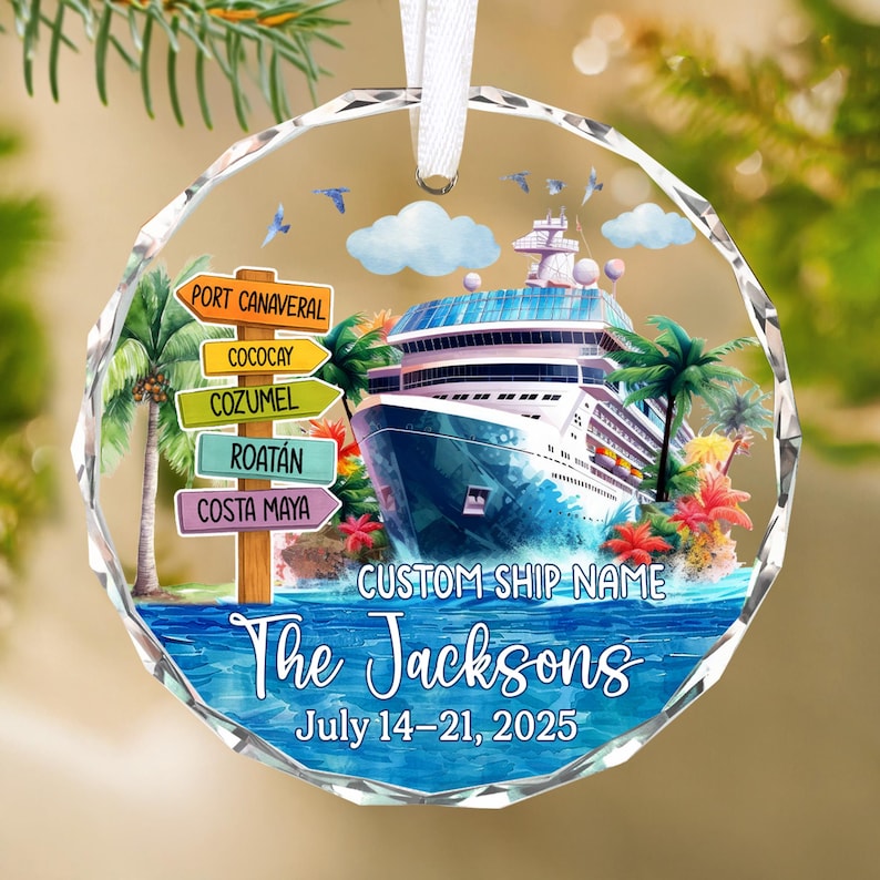 May include: A clear, round Christmas ornament with a cruise ship design. The ornament features a cruise ship, palm trees, and directional signs to various ports. Text includes "The Jacksons" and "July 14-21, 2025". A white ribbon is attached for hanging.