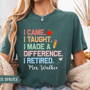 May include: Teal blue t-shirt with a colorful graphic that reads "I came. I taught. I made a difference. I retired. Mrs. Walker."