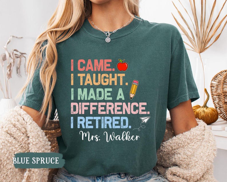 May include: Teal blue t-shirt with a colorful graphic that reads "I came. I taught. I made a difference. I retired. Mrs. Walker."