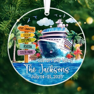 May include: A round Christmas ornament featuring a cruise ship on blue water with palm trees and flowers. The ornament has text that reads "The Jacksons" and "July 14-21, 2025". Destination signs point to Port Canaveral, Cozumel, and other locations.