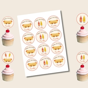 May include: A sheet of cupcake toppers with a hot dog and condiment theme. The toppers are round with the text "Happy Birthday Frankie". Cupcakes with pink frosting and a cherry are also shown.