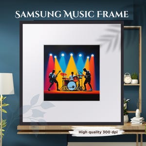 May include: A framed print featuring a band performing on stage under colorful spotlights. The image has a black frame and a white mat. The text "SAMSUNG MUSIC FRAME" is at the top. The bottom of the frame has the text "High quality 300 dpi".