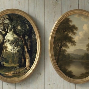 May include: Two oval-framed landscape paintings. One depicts a forest path, the other a river scene with mountains. Both feature gold-colored frames and are mounted on a light wood-paneled wall.