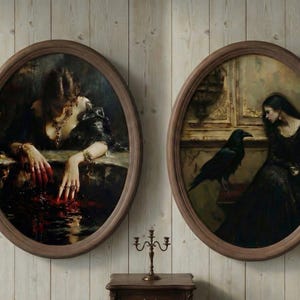 May include: Two oval framed paintings hang on a wood-paneled wall. The paintings depict women in dark clothing, one with blood-red hands, the other with a raven. A small candle holder and table are below.