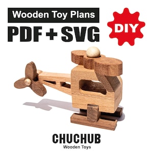 以下が含まれることがあります： プロペラと小さなボールが付いた木製のおもちゃのヘリコプター。画像には「Wooden Toy Plans PDF + SVG」と赤い星の「DIY」という文字が含まれています。「CHUCHUB Wooden Toys」というブランド名も表示されています。