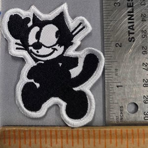 May include: Embroidered patch featuring the classic cartoon character Felix the Cat. The patch is black and white with a white border. The patch is approximately 2.5 inches in height.