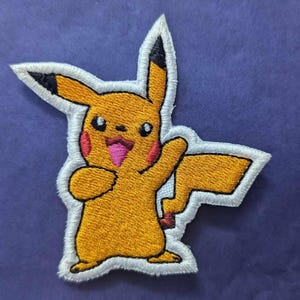 May include: An embroidered patch featuring Pikachu, a well-known cartoon character from the Pokemon franchise, in yellow with a white outline and red blush on its cheeks.