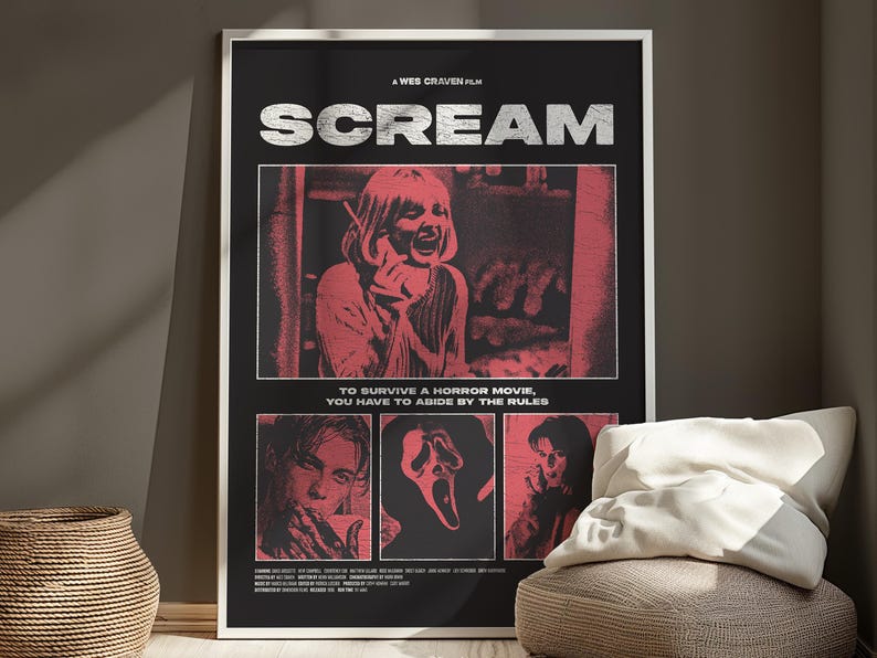 May include: A framed movie poster for the film "Scream" with a black background and red and white graphics. The poster features the film's title, images from the movie, and the text "TO SURVIVE A HORROR MOVIE, YOU HAVE TO ABIDE BY THE RULES."