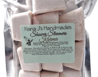 May include: A bag of white shower steamers labeled "Nana J's Handmades Shower Steamers Karma". The label includes the ingredients and directions for use.
