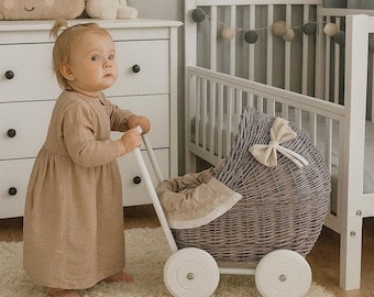 Lili wicker doll stroller with beige trim, blanket, and pillow