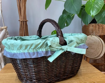 Handwoven wicker basket with handle and fabric liner, made from natural willow