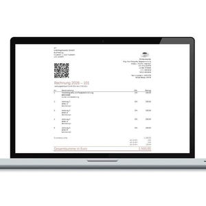 May include: A silver laptop displaying a digital invoice titled Rechnung 2026-101 on its screen. The document includes a QR code, company address details, a list of services with corresponding amounts, and a final total sum of 1500.00 Euros.